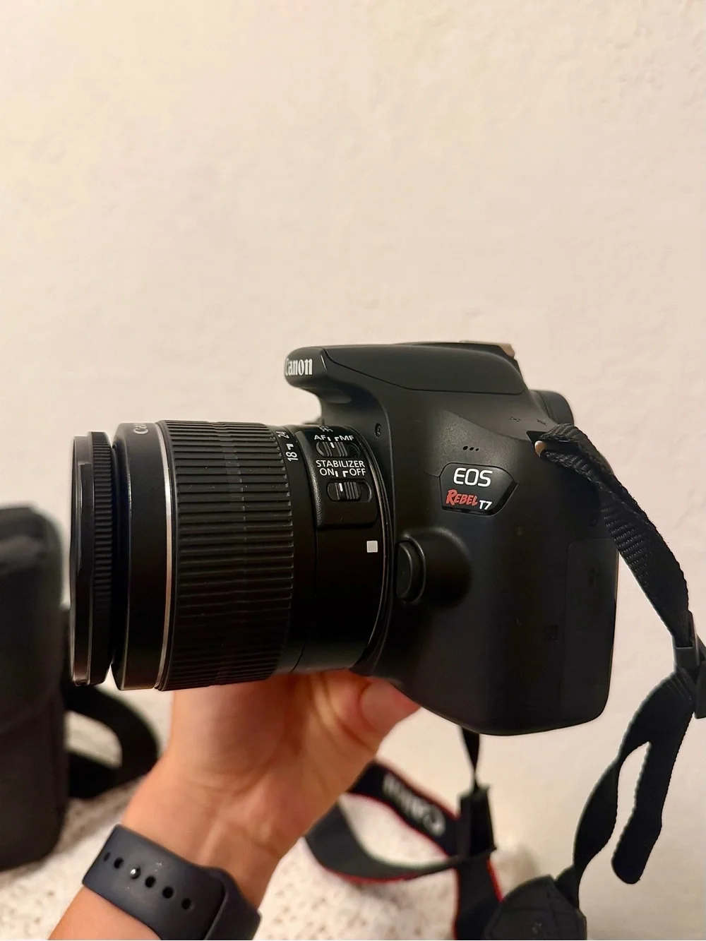 Canon DSLR Camera with Zoom Lens and Black Carrying Bag